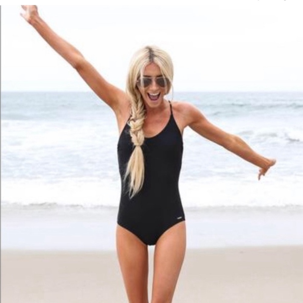 One piece black swimsuit. Stevie Hender.